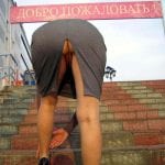 mature madam in a cafe flashing a naked pussy