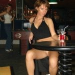 Texting on bench bottomless drinking a beer