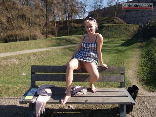 Sitting barefoot in short dress without knickers