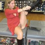 Bottomless MILF in red posing in public warehouse