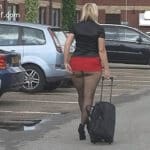 Bare ass blonde in very short black skirt walking black dog out