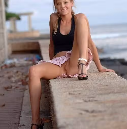 Cute teen posing without panties at sea shore
