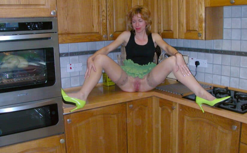 MILF spreading legs on kitchen platform without panties