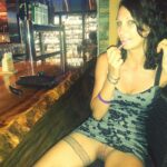 Pretty girl smilingly flashing her pussy in a bar. The guy is…