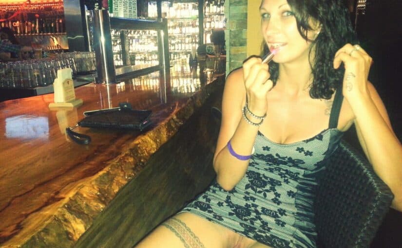 Sexy babe flashing pussy at bar