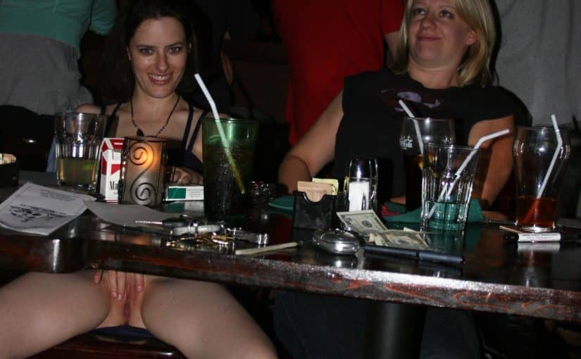 Naughty babe exposing her pussy at bar