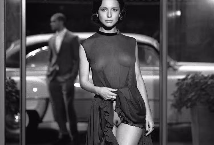 a lady in a black transparent dress