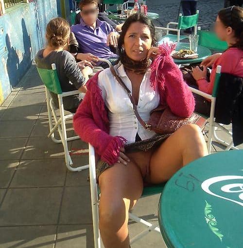 a mature lady is sitting in a cafe bottomless