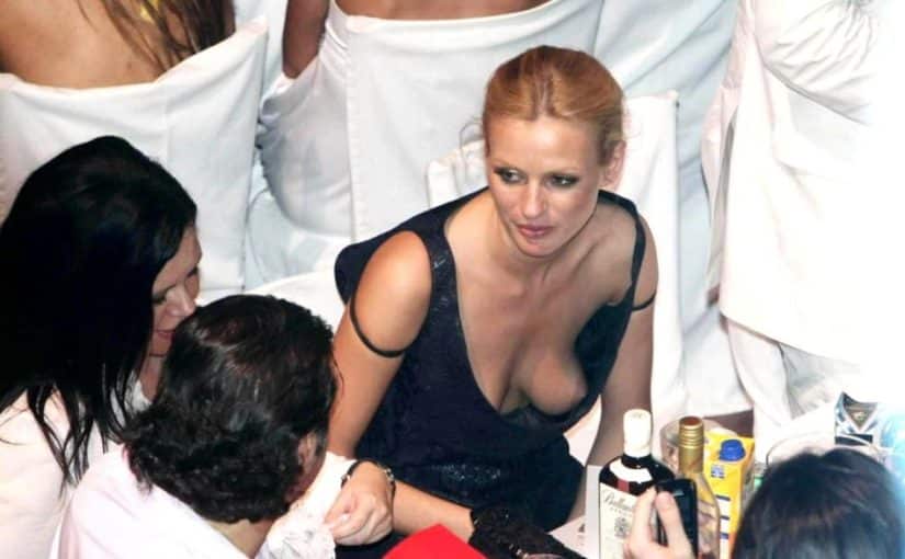 breasts flashed from under a black dress
