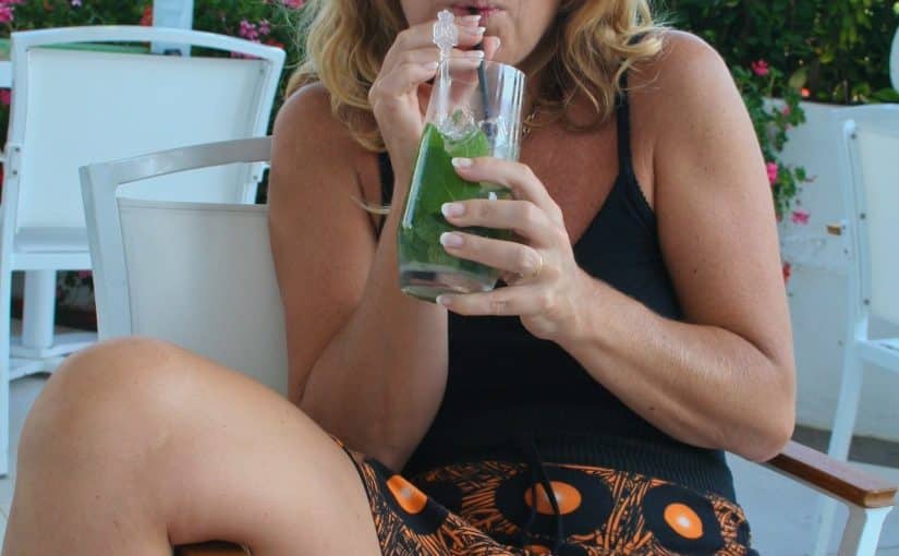 mature bottomless mom drinks a cocktail