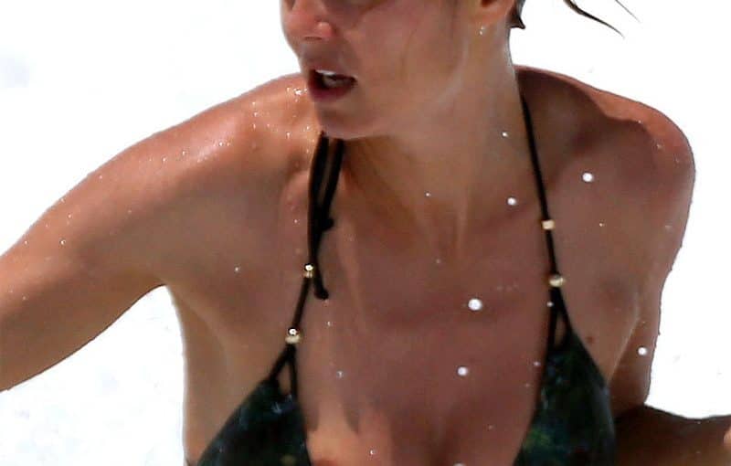 nipple slipped out from the black swimsuit