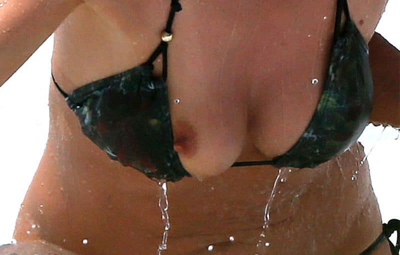 small nipple slipped out from black swimsuit