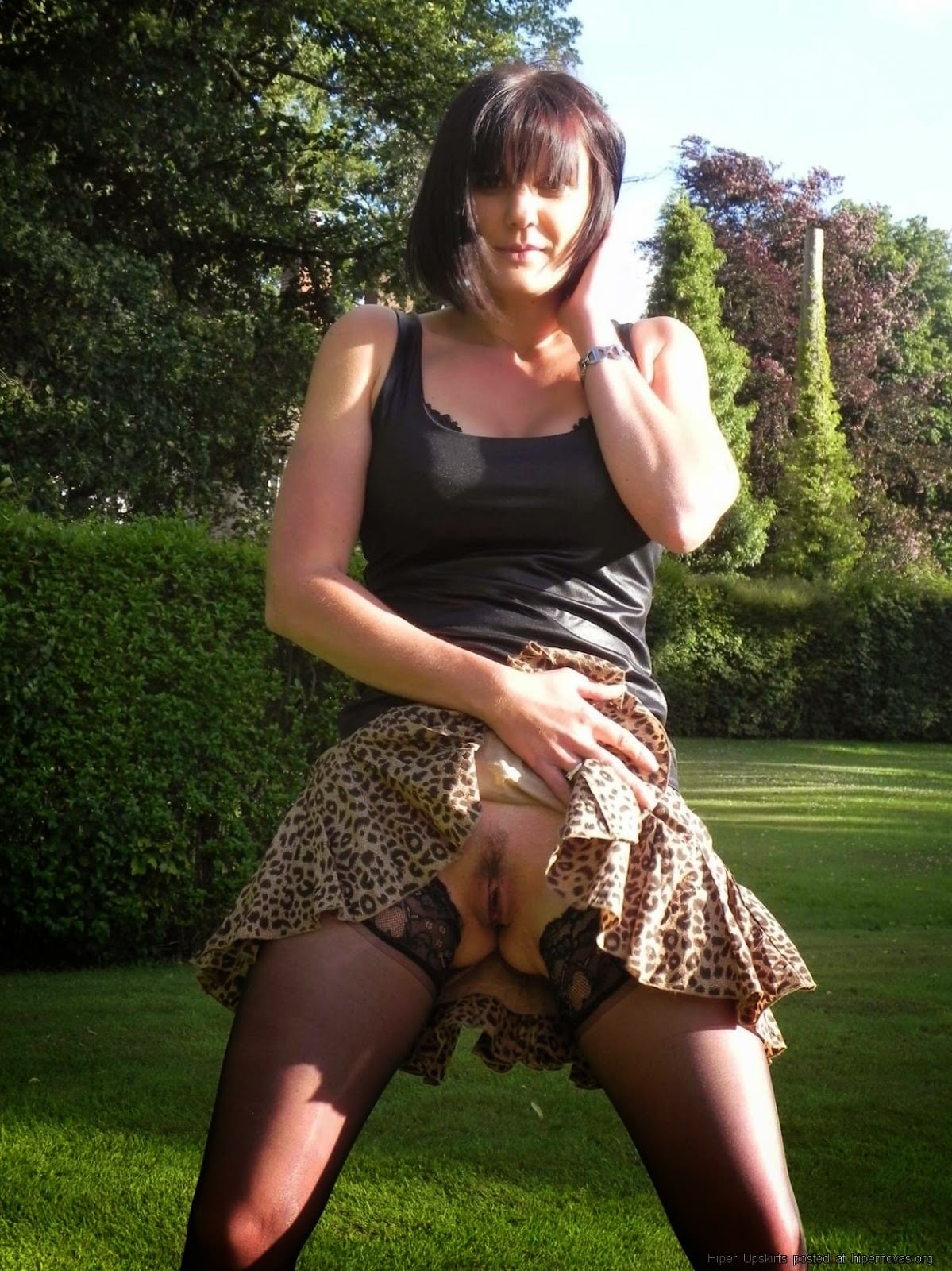 upskirt pussy flash hairy pussy dark haired brunette bottomless under the leopard skirt is a naked pussy
